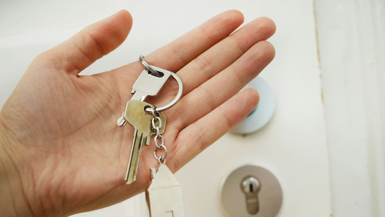 A set of keys resting in an open hand — ownership, not a lease