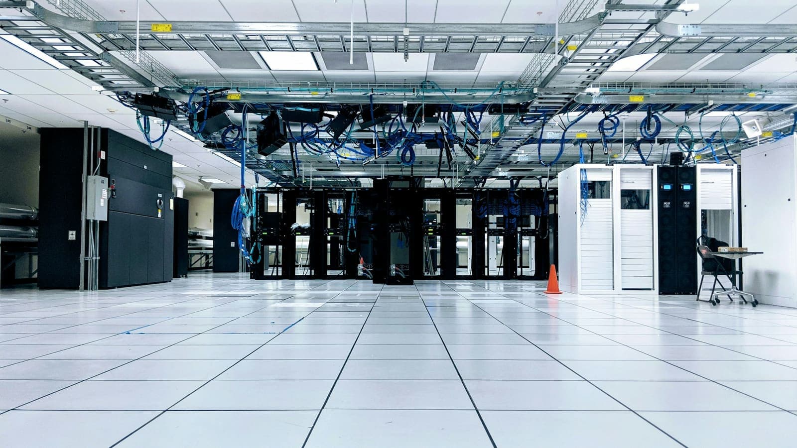 Rows of server racks in a dimly lit data centre