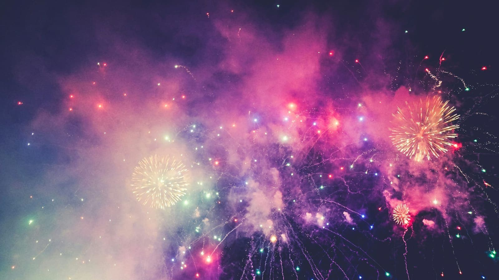 Multicoloured fireworks bursting in the night sky — spectacular, then gone