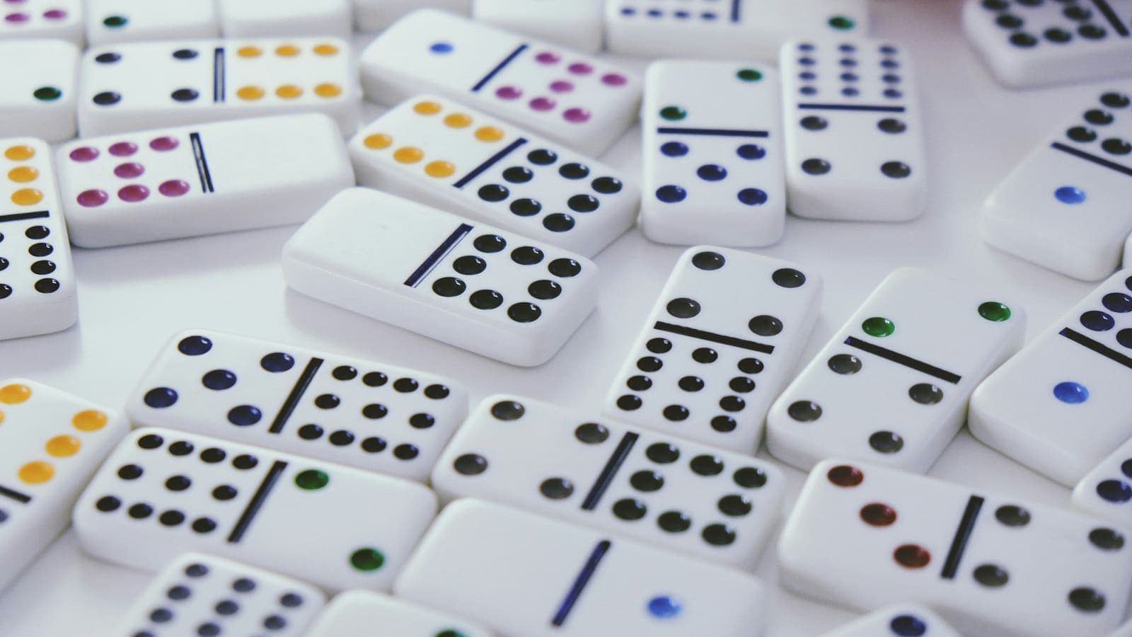 A line of domino tiles standing on end — one push and the whole chain goes